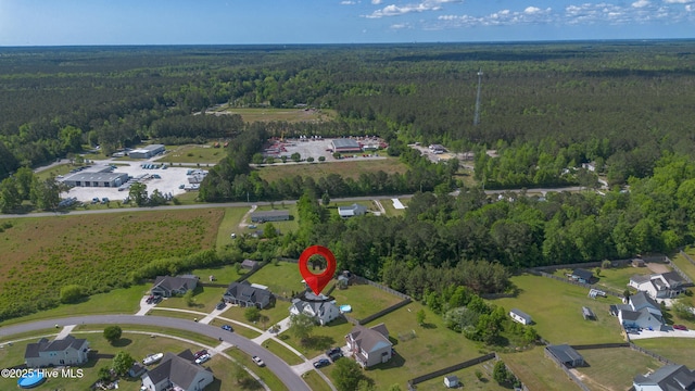 birds eye view of property with a wooded view