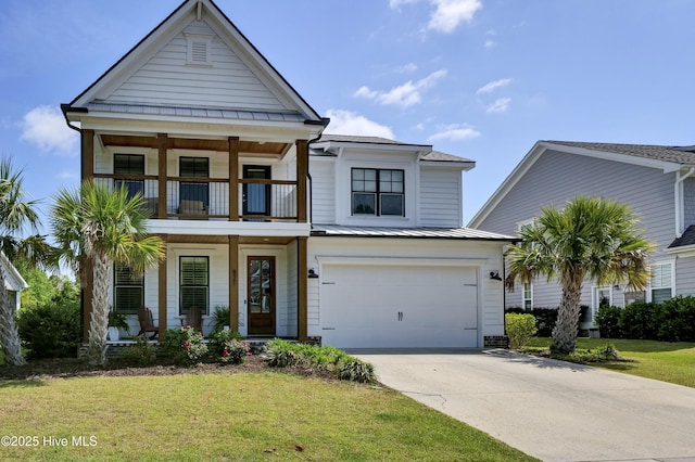 view of front of property featuring an attached garage, a front lawn, a balcony, driveway, and a standing seam roof