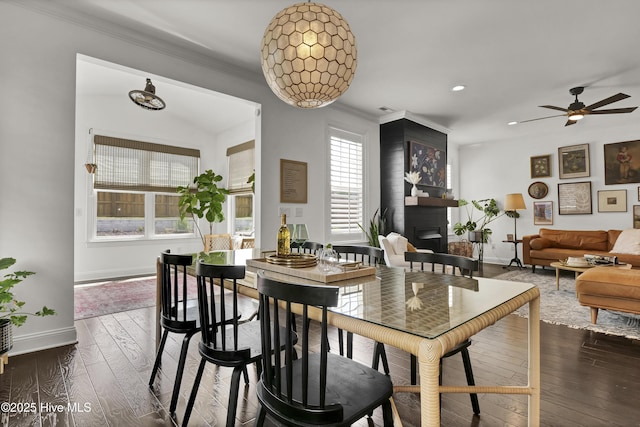 dining space with crown molding, baseboards, a ceiling fan, and a healthy amount of sunlight