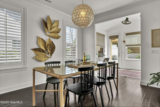 dining room featuring crown molding, baseboards, dark wood-style floors, and a healthy amount of sunlight
