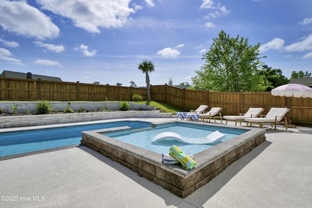 view of pool featuring a fenced backyard, a patio area, and a pool with connected hot tub