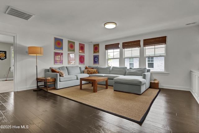 living area with baseboards, dark wood-style floors, and visible vents