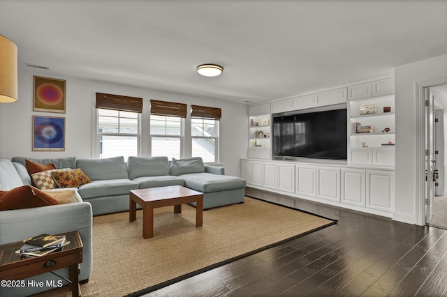 living room featuring visible vents and dark wood finished floors