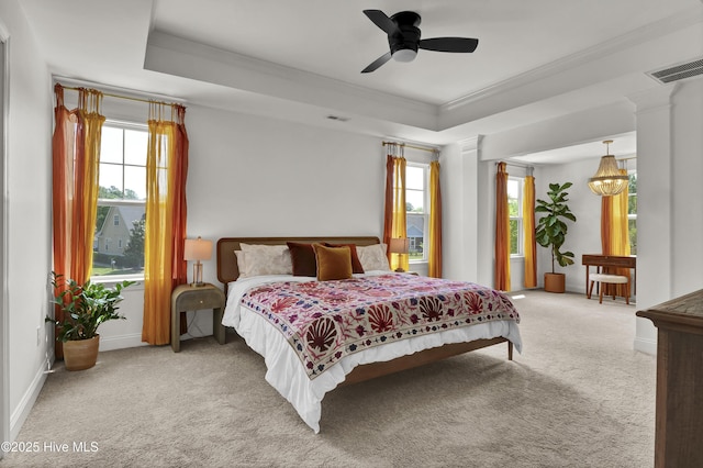carpeted bedroom featuring ornamental molding, visible vents, and multiple windows
