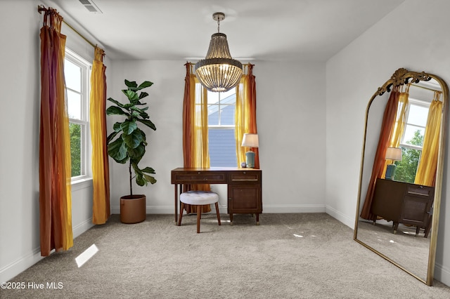 sitting room featuring carpet flooring, a wealth of natural light, and a notable chandelier
