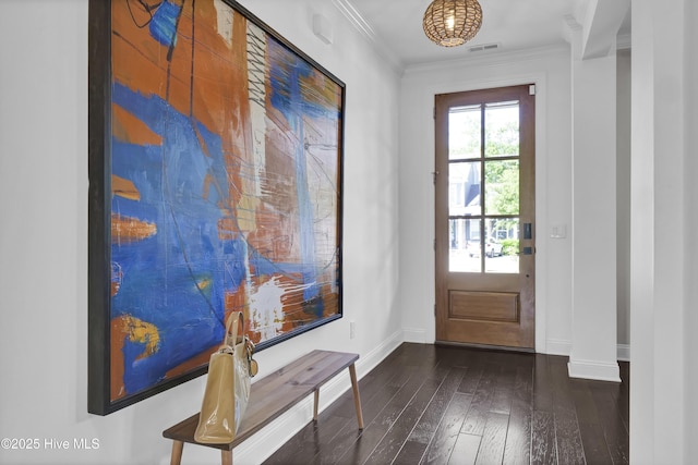 entryway featuring crown molding, baseboards, dark wood-type flooring, and visible vents