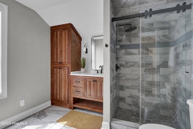 full bathroom featuring vanity, a shower stall, and marble finish floor
