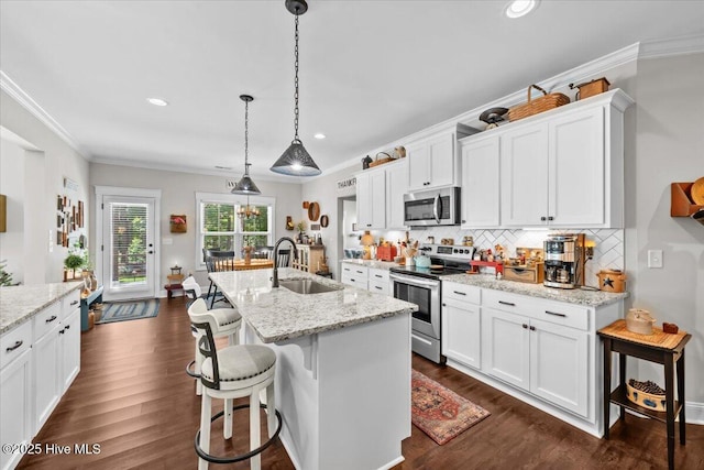 549 Abbey Rd, Carthage, NC 28327 - kitchen with appliances with stainless steel finishes, a sink, white cabinets, ornamental molding, and tasteful backsplash