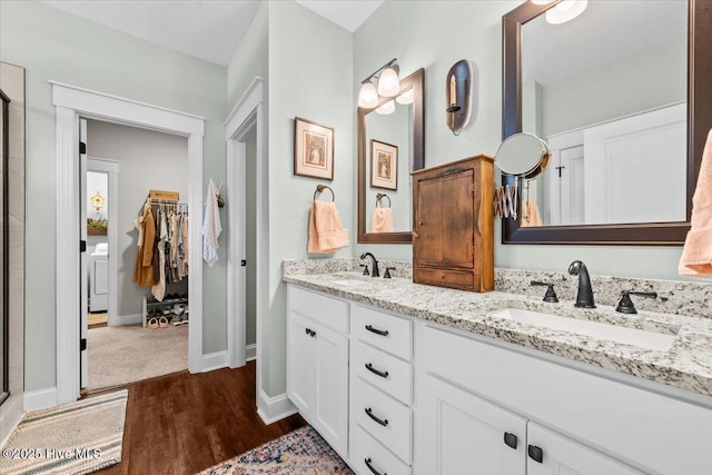 549 Abbey Rd, Carthage, NC 28327 - full bath featuring wood finished floors, double vanity, a shower with door, baseboards, and a walk in closet