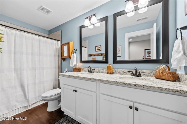 549 Abbey Rd, Carthage, NC 28327 - full bathroom featuring wood finished floors, toilet, double vanity, and curtained shower