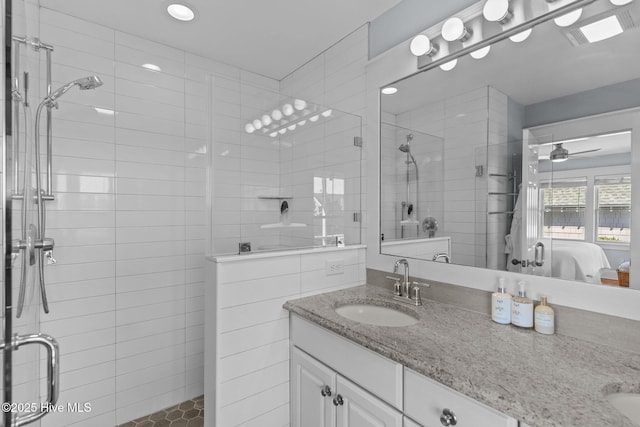 bathroom with a shower stall, ensuite bath, vanity, and recessed lighting