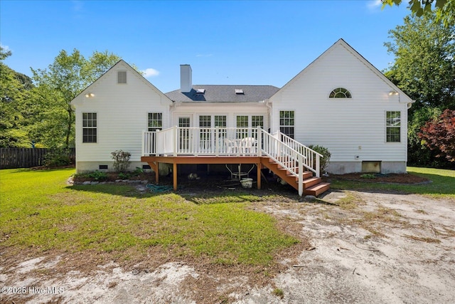 rear view of house featuring a wooden deck, fence, a chimney, crawl space, and a yard