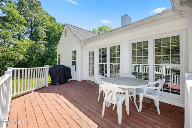 wooden terrace with outdoor dining area