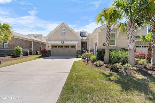 9036 Island Rider Ct NE, Leland, NC 28451 - view of front of property featuring an attached garage, a front yard, driveway, and stone siding