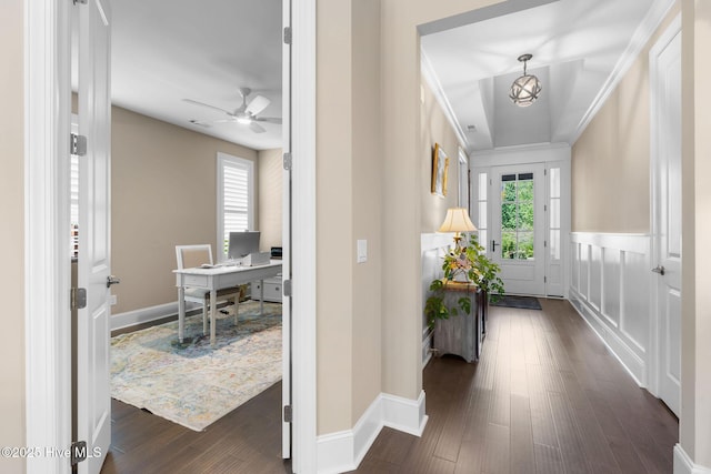 9036 Island Rider Ct NE, Leland, NC 28451 - hall featuring plenty of natural light, dark wood-style flooring, a notable chandelier, and wainscoting