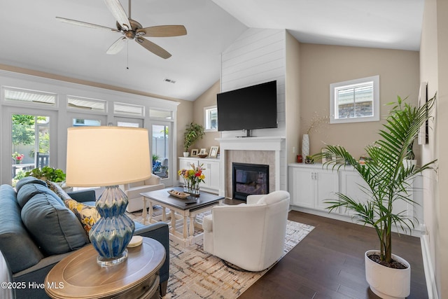 9036 Island Rider Ct NE, Leland, NC 28451 - living area with ceiling fan, visible vents, a fireplace, vaulted ceiling, and wood finished floors
