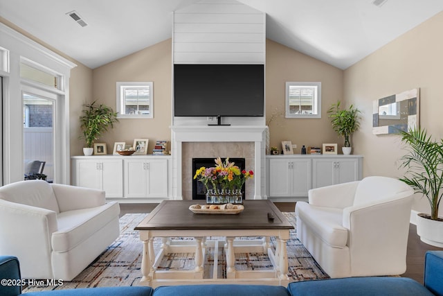 9036 Island Rider Ct NE, Leland, NC 28451 - living area featuring visible vents, lofted ceiling, a tile fireplace, and wood finished floors