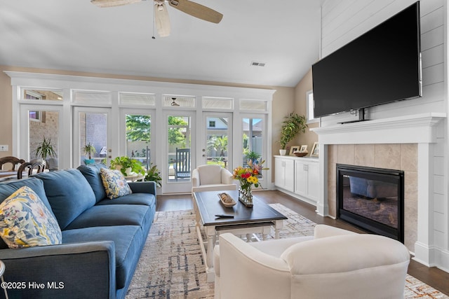 9036 Island Rider Ct NE, Leland, NC 28451 - living room with a tiled fireplace, ceiling fan, wood finished floors, and visible vents