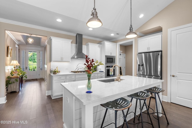 9036 Island Rider Ct NE, Leland, NC 28451 - kitchen with crown molding, wall chimney exhaust hood, appliances with stainless steel finishes, and a kitchen breakfast bar