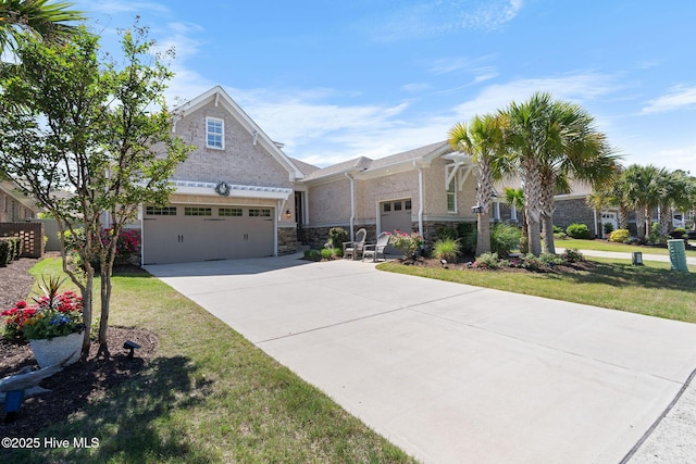 9036 Island Rider Ct NE, Leland, NC 28451 - craftsman house featuring concrete driveway, a front lawn, and stone siding