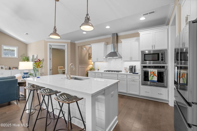 9036 Island Rider Ct NE, Leland, NC 28451 - kitchen featuring a sink, wall chimney exhaust hood, stainless steel appliances, lofted ceiling, and visible vents