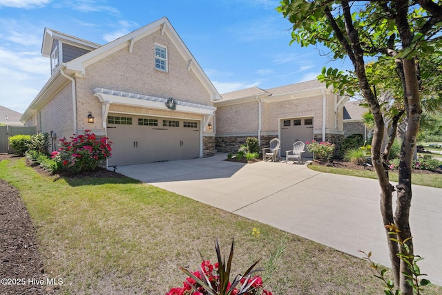 9036 Island Rider Ct NE, Leland, NC 28451 - view of front of home with brick siding, driveway, stone siding, and a front lawn