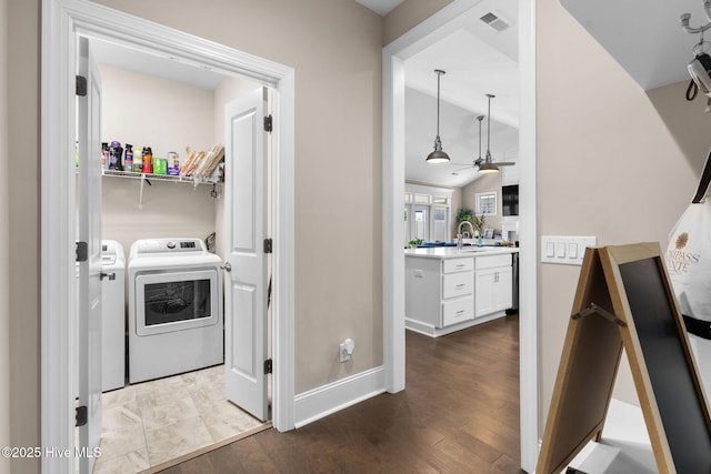 9036 Island Rider Ct NE, Leland, NC 28451 - laundry area with laundry area, visible vents, dark wood finished floors, baseboards, and washer and dryer