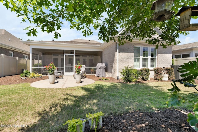 9036 Island Rider Ct NE, Leland, NC 28451 - rear view of house featuring a fenced backyard, a lawn, a patio, and a sunroom