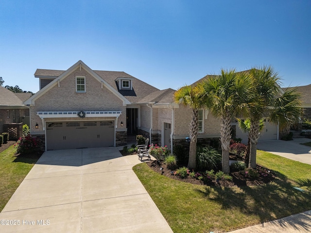9036 Island Rider Ct NE, Leland, NC 28451 - view of front of property featuring a garage, stone siding, driveway, and a front yard