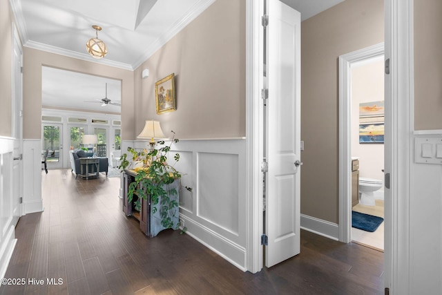 9036 Island Rider Ct NE, Leland, NC 28451 - hall with crown molding, dark wood finished floors, a decorative wall, and wainscoting