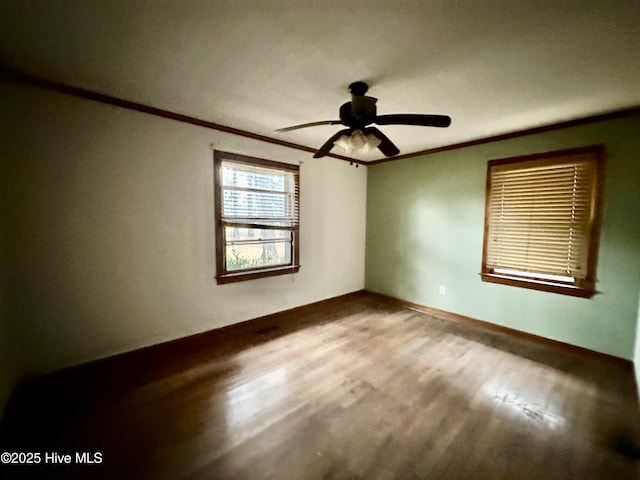 empty room featuring crown molding, ceiling fan, and wood finished floors