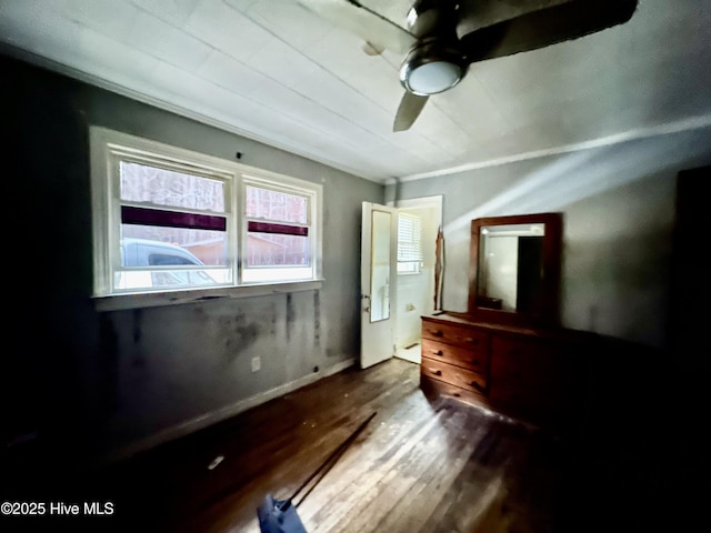 unfurnished bedroom with ceiling fan and wood finished floors