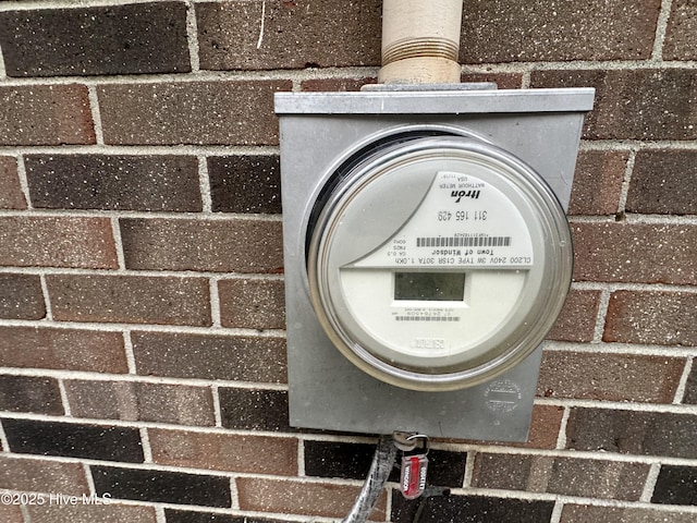 exterior details with electric meter and brick siding