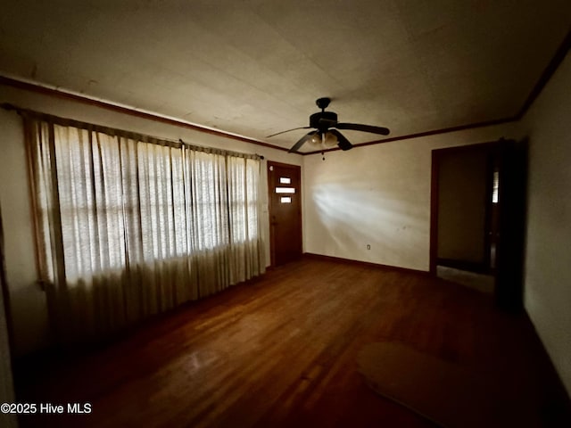 unfurnished living room featuring crown molding, ceiling fan, and wood finished floors