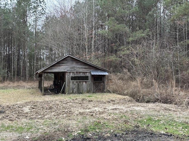 view of outdoor structure with an outdoor structure and a forest view