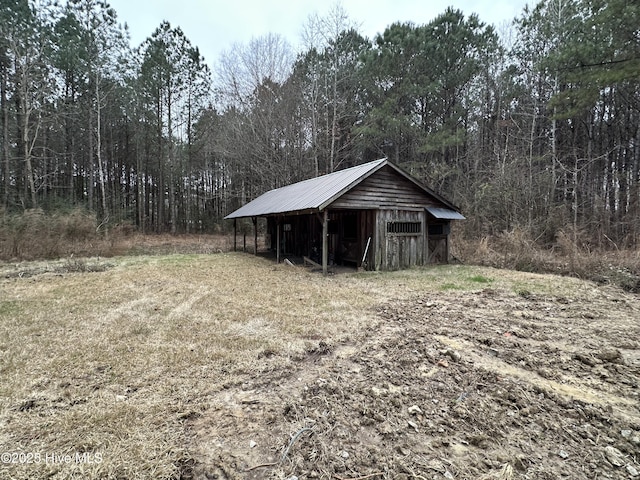 view of pole building with a wooded view