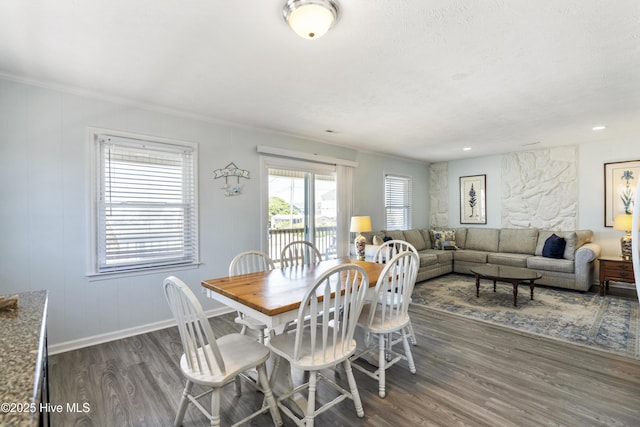 dining space with baseboards, ornamental molding, and dark wood-type flooring