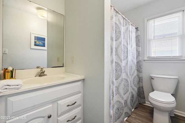 full bathroom with vanity, toilet, and wood finished floors