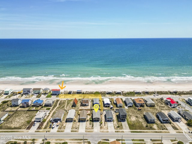 drone / aerial view featuring a water view and a view of the beach