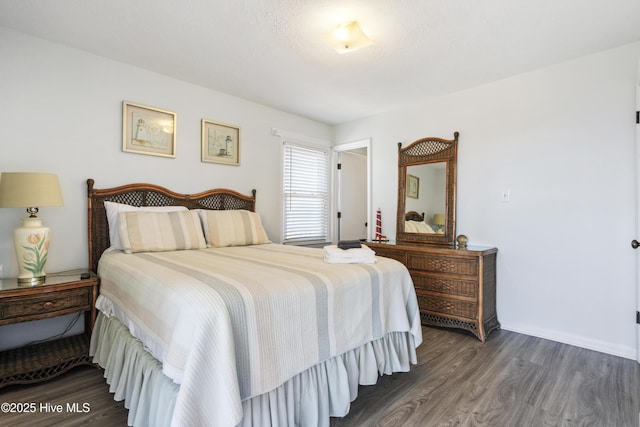 bedroom featuring baseboards and wood finished floors