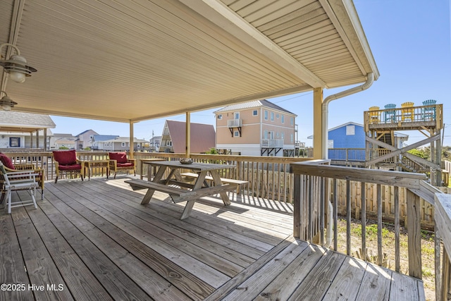 wooden deck featuring a residential view and outdoor dining space