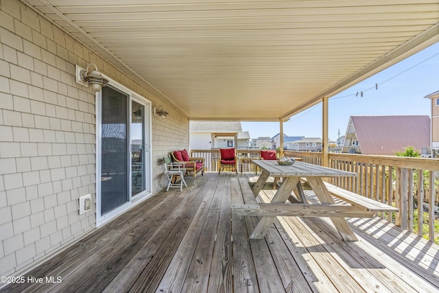 wooden deck with a residential view and outdoor dining area