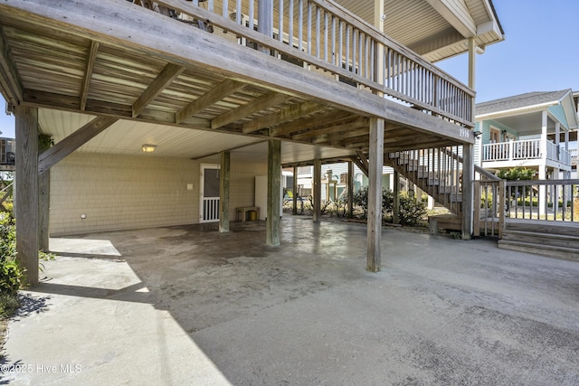 view of patio with driveway, stairs, and a carport