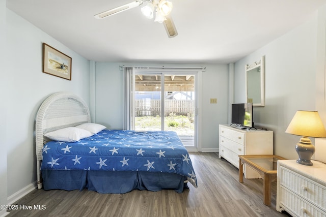 bedroom featuring ceiling fan, baseboards, access to outside, and wood finished floors