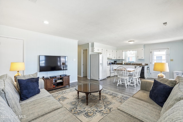 living room with visible vents and dark wood-style flooring