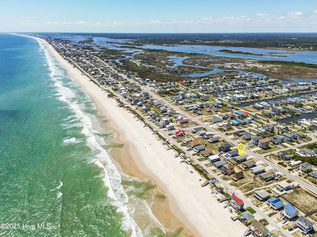 birds eye view of property with a beach view and a water view