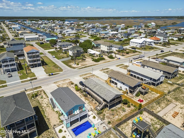 drone / aerial view featuring a water view and a residential view