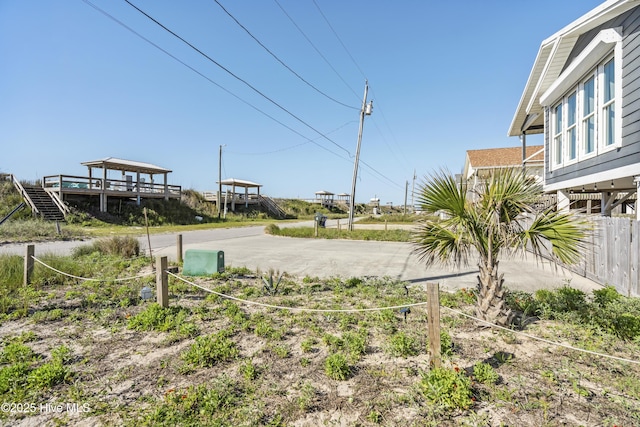 view of yard with fence and driveway