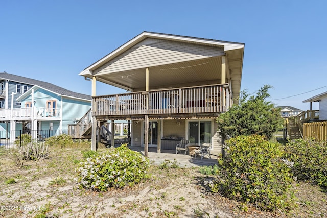 back of property with fence, stairs, a deck, and a patio