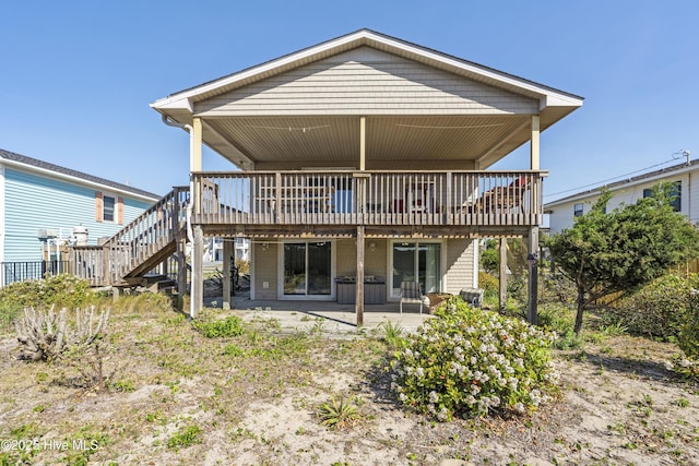 rear view of property with stairway, a patio, and a wooden deck